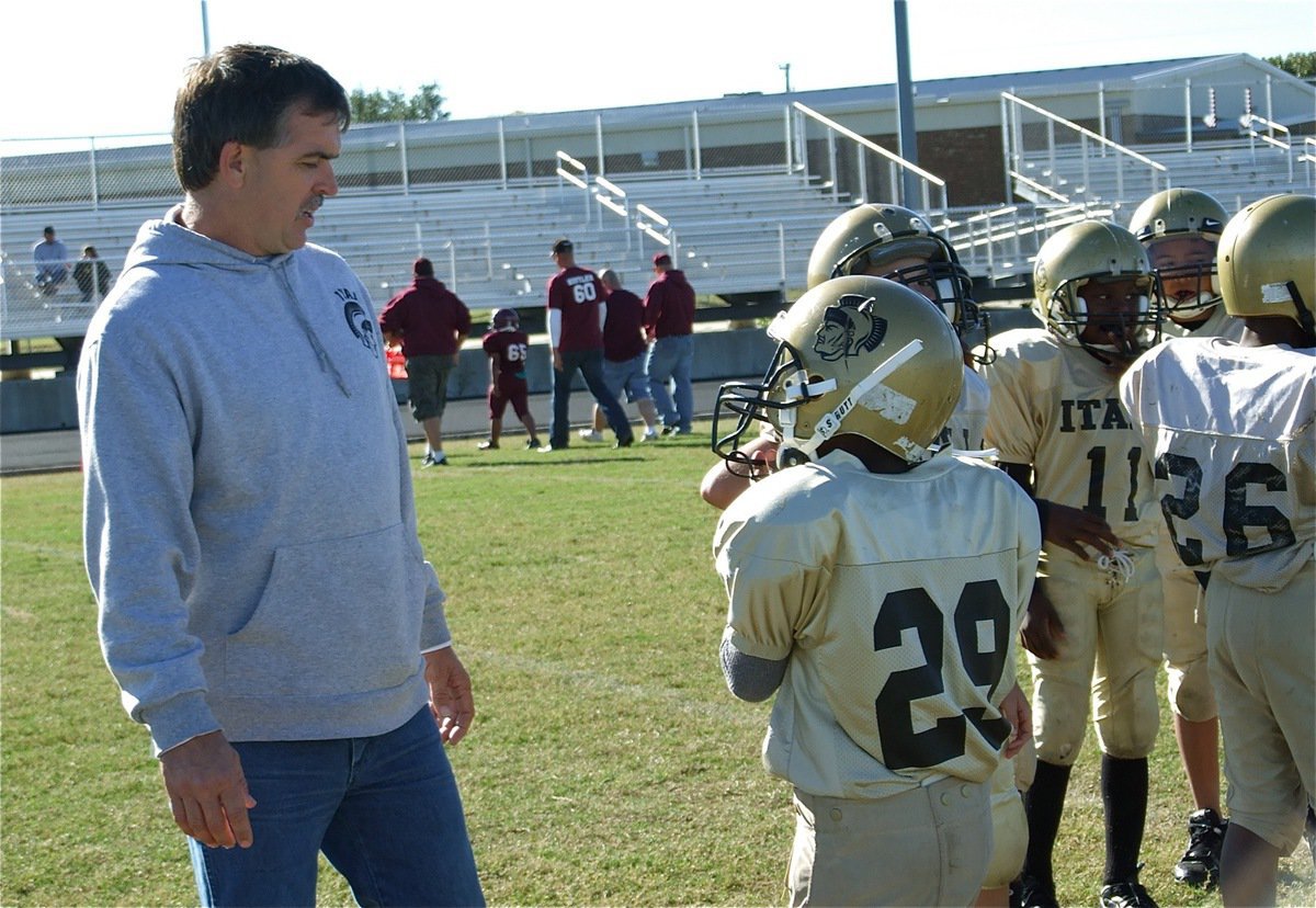 Image: Christian gets the play — B-Team head coach Gary Wood discusses an upcoming play with Christian Cole.