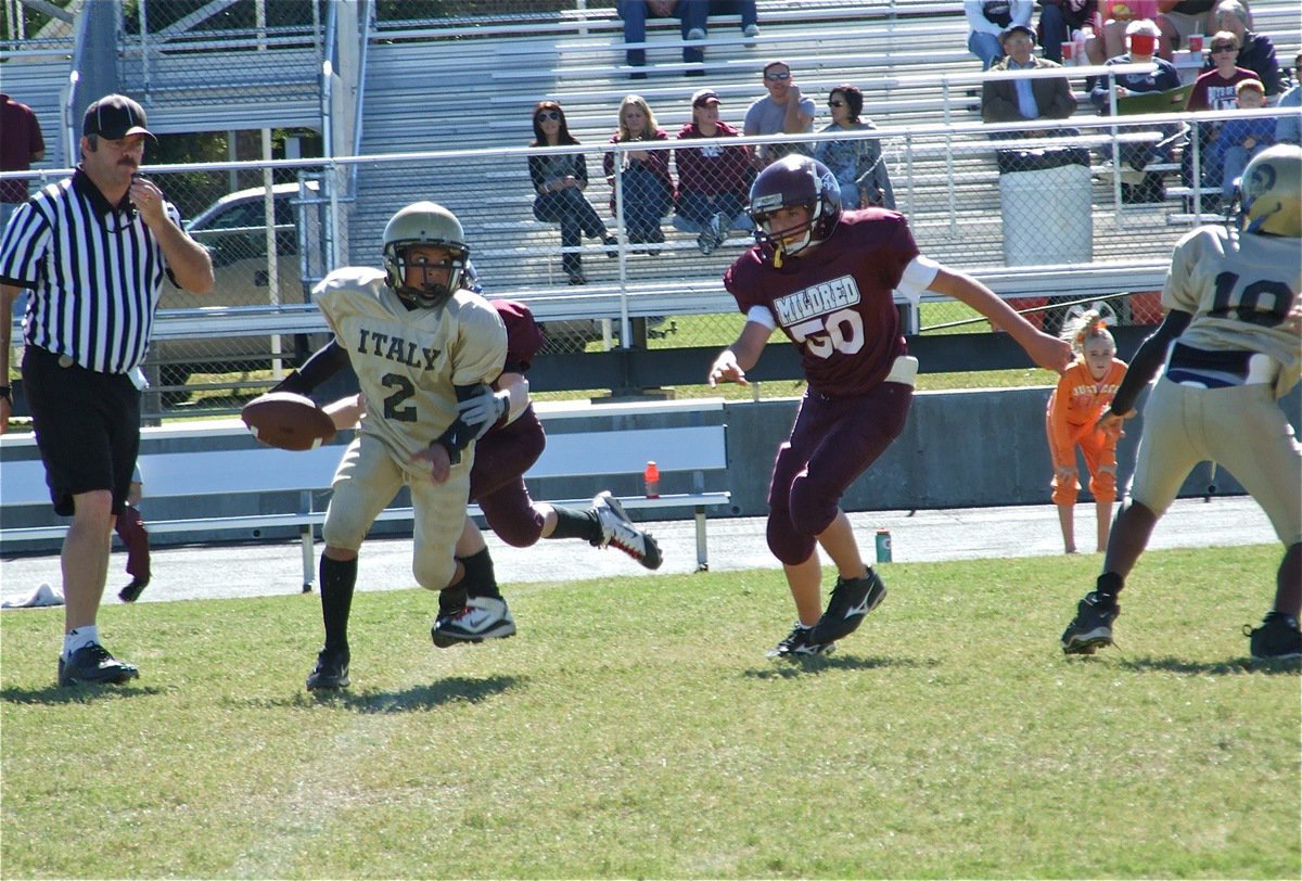 Image: Tylan tries to escape — Tylan Wallace(2) tries to out maneuver Mildred’s defenders, but in the end, Mildred’s A-Team won 13-12.