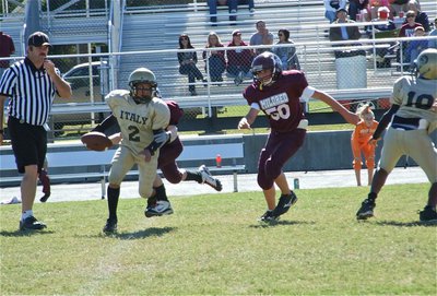 Image: Tylan tries to escape — Tylan Wallace(2) tries to out maneuver Mildred’s defenders, but in the end, Mildred’s A-Team won 13-12.