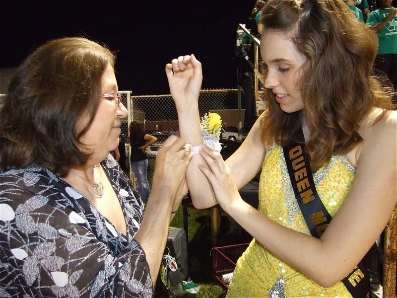 Image: Mom’s loving help — 2010 Homecoming Queen Nominee Melissa Smithey gets help from her mother, Rita, before the halftime festivities.