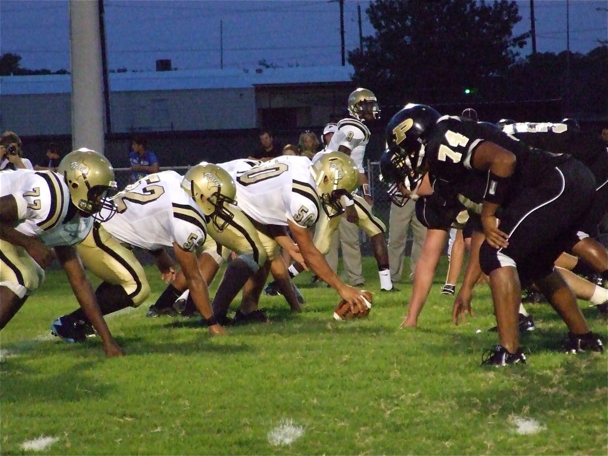 Image: Crossing the line — Italy’s Larry Mayberry(77), Jacob Lopez(52) , Ethan Simon(50) and receiver Devonta Simmons(9) cross the line and get over a hurdle against the Palmer Bulldogs.