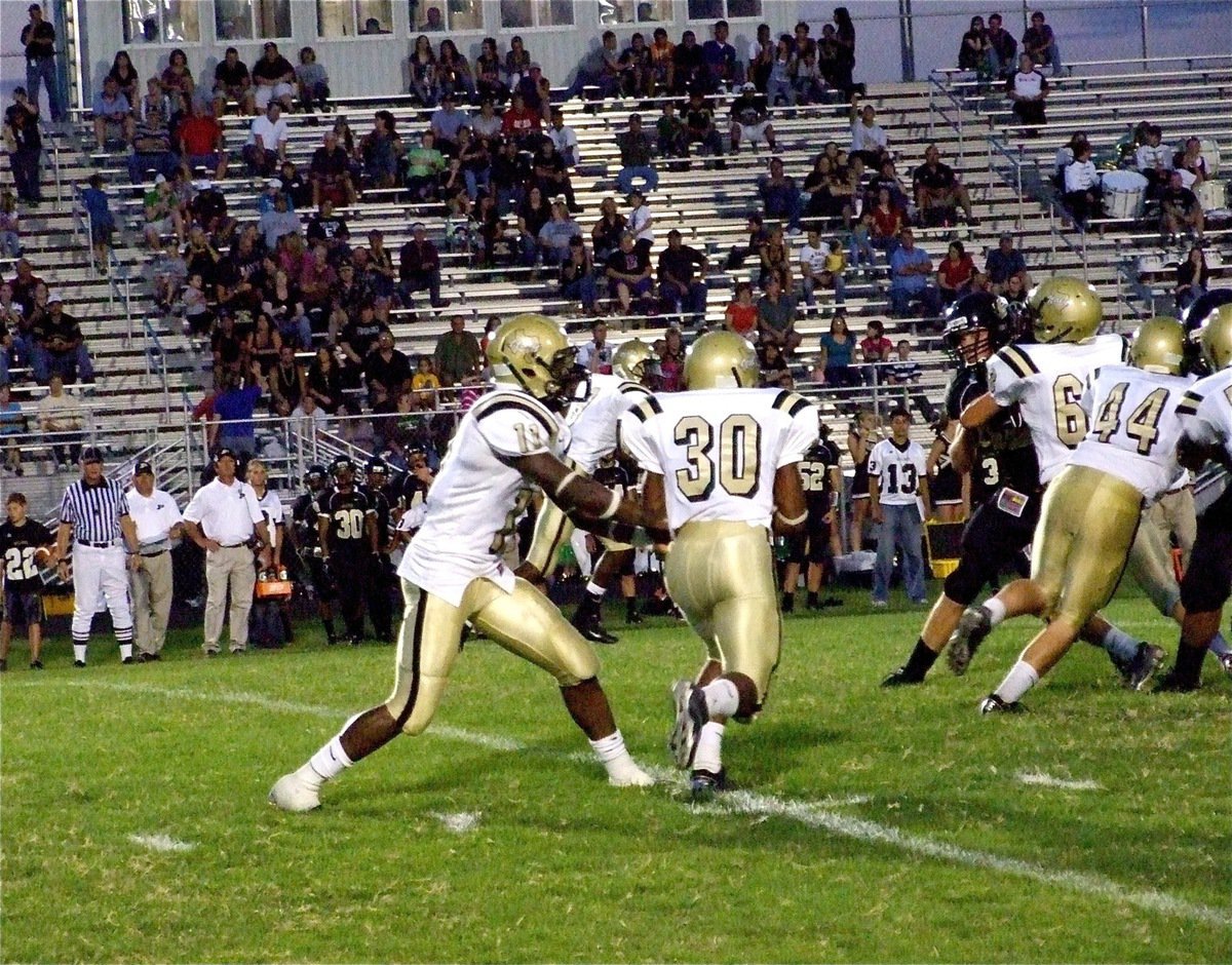 Image: There goes Jamal! — Jalarnce Jamal Lewis(30) takes the handoff from Jasenio Aderson(11) and follows blockers Ethan Saxon(44) and Brandon Souder(63).