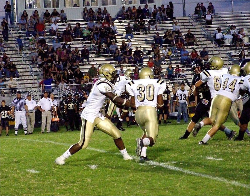 Image: There goes Jamal! — Jalarnce Jamal Lewis(30) takes the handoff from Jasenio Aderson(11) and follows blockers Ethan Saxon(44) and Brandon Souder(63).