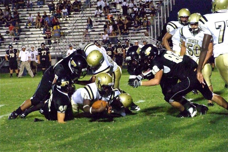 Image: Nose dive — Jasenio Anderson(11) strectches for one more yard.