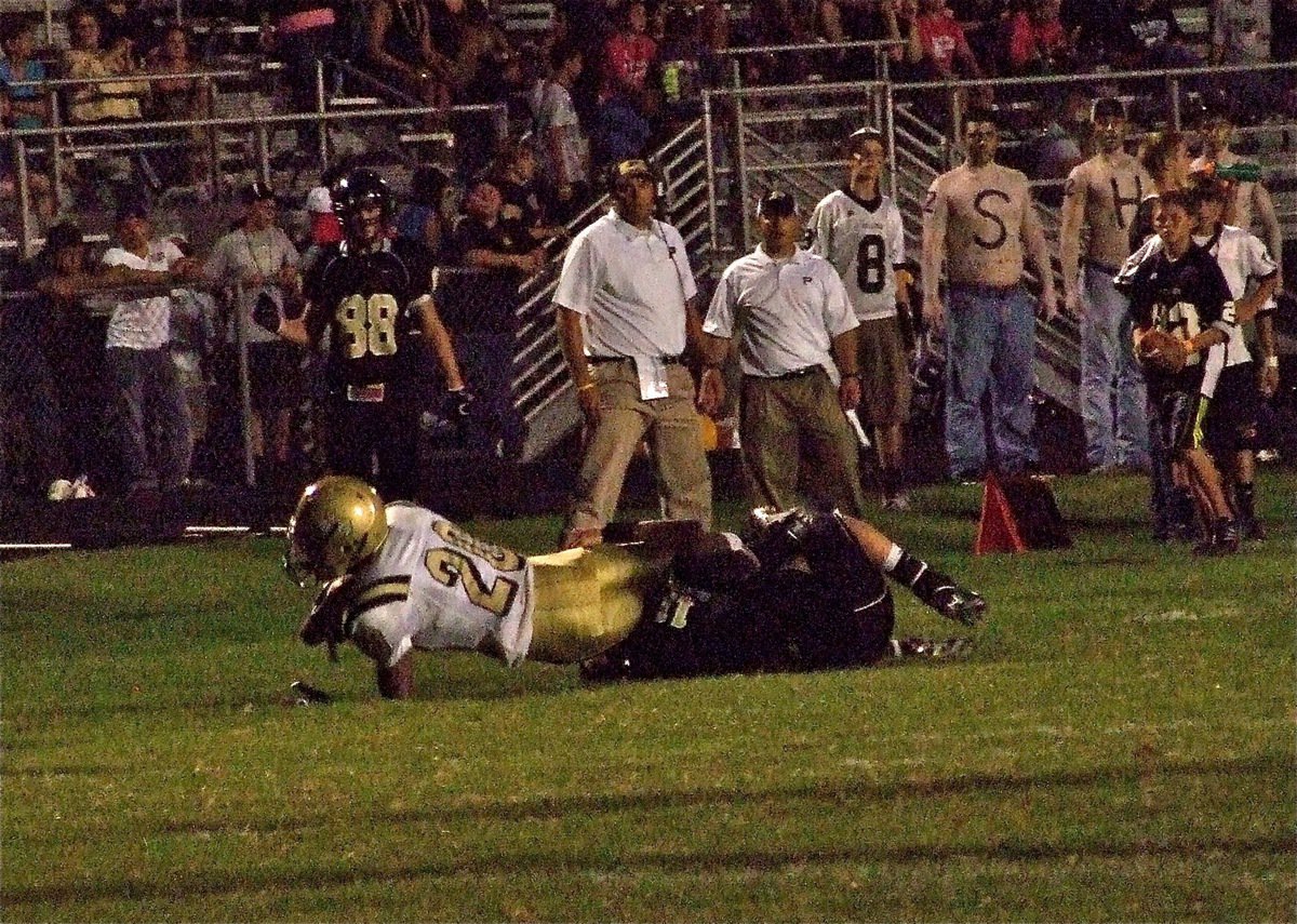 Image: In the Red Zone — Italy’s De’Andre Sephus(20) catches a 26-yard pass before being tackled by a Bulldog defender in the second half.