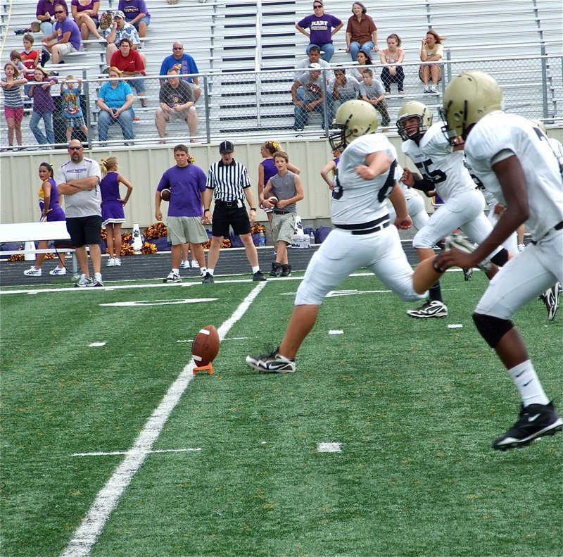 Image: The approach — Kevin Roldan(60) kicks off for the JV Gladiators.