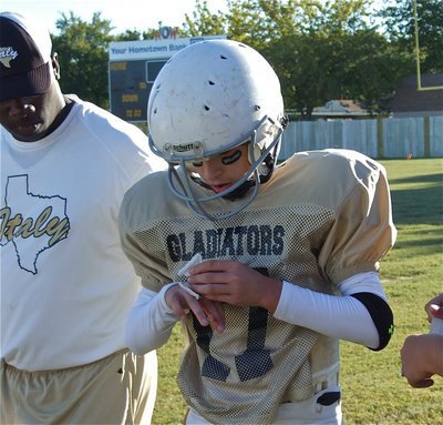 Image: Medic! — Gladiator quarterback Ryan Connor injures his throwing hand but eventually returns to the game.