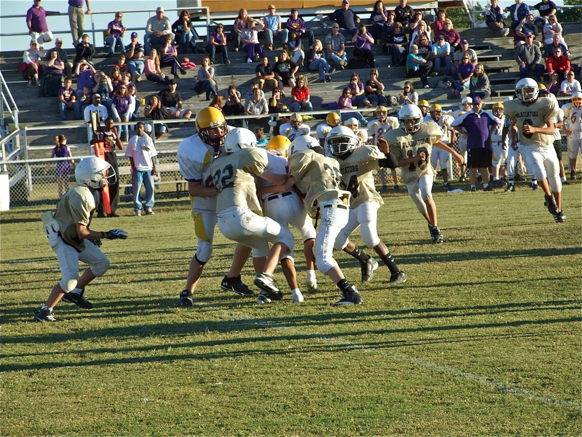 Image: Help from friends — Cody Boyd(22), Caden Petrey(35) and Tony Wilson(24) converge on a Bison Runner.
