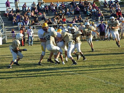 Image: Help from friends — Cody Boyd(22), Caden Petrey(35) and Tony Wilson(24) converge on a Bison Runner.