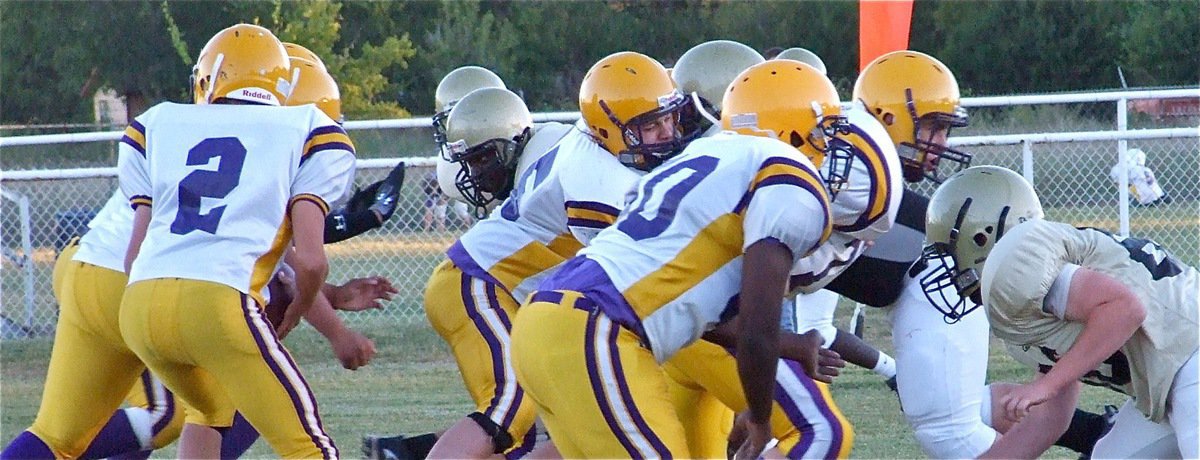 Image: Surge of gold — Italy’s Adrian Reed, Hank Seabolt and Jake Escamilla surge into the Bison backfield.