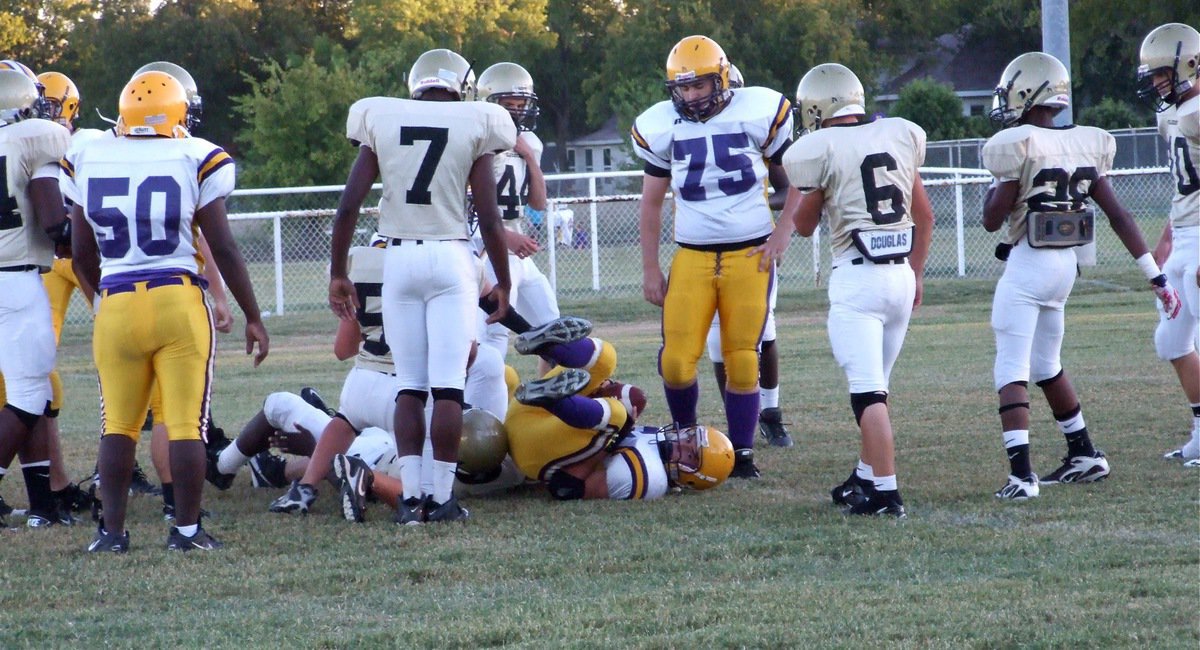 Image: The take down — Bailey Walton(52) and Travis Cockerham(32) take down the Bison quarterback.
