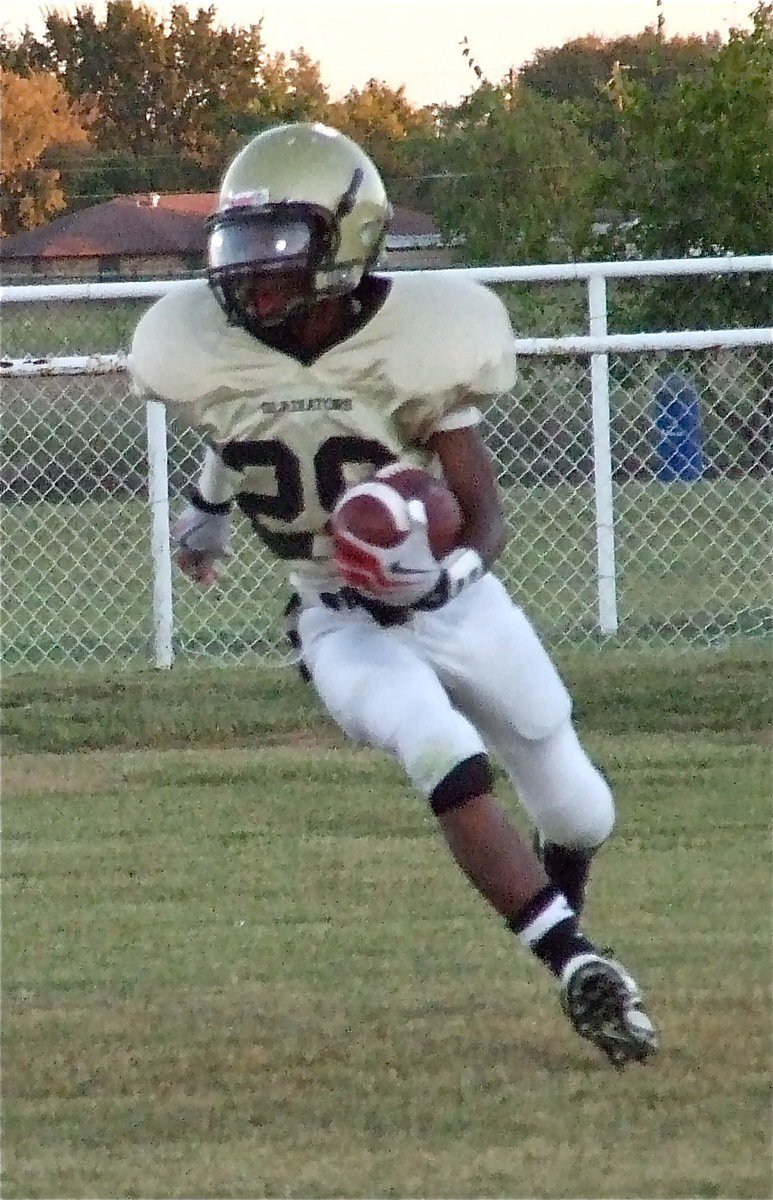 Image: Carson gains yards — Eric Carson(28) runs back the kickoff for a big gain.
