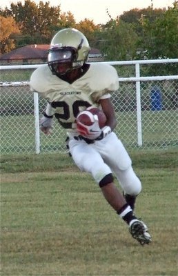 Image: Carson gains yards — Eric Carson(28) runs back the kickoff for a big gain.