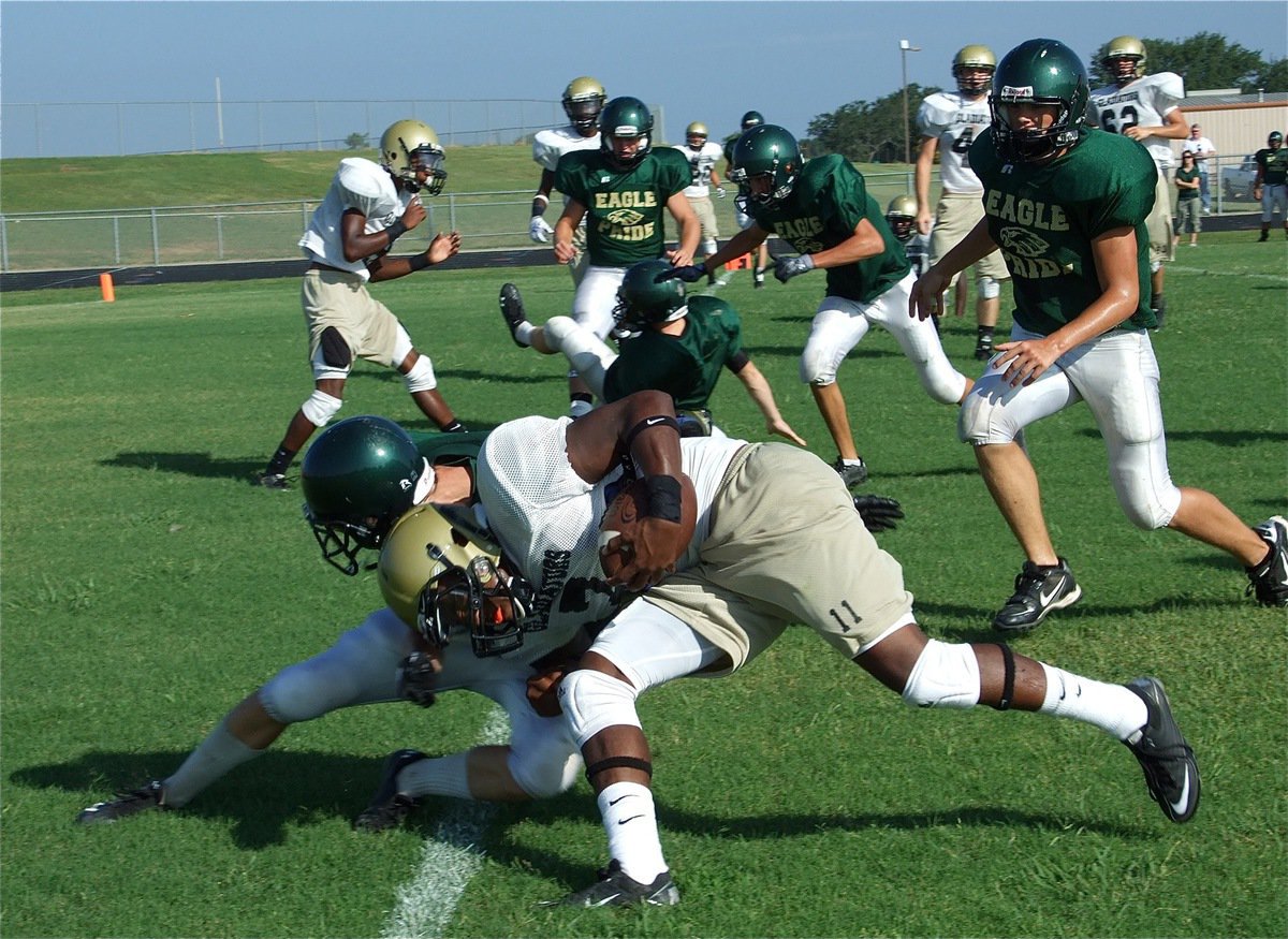 Image: Gladiator quarterback Jasenio Anderson wins wreck at goal line — Italy Gladiator quarterback Jasenio Anderson flies past Valley Mills defenders and then crashes thru an unlucky Eagle to put Italy up 1-0 during a scrimmage on Saturday in Valley Mills.