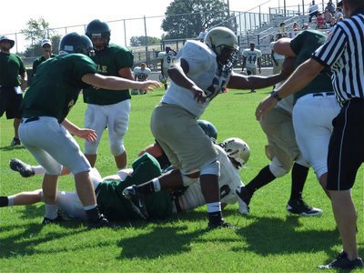 Image: 2-0 Italy — Gladiators’ linemen Bobby Wilson(50) and Jacob Lopez push the Valley Mills defense back allowing Justin Buchanan to fight his way into the endzone for Italy’s second score of the scrimmage.