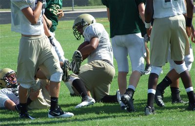 Image: I got it! — Jacob Lopez recovers a fumble for coach Jeff Richters and the Gladiators defense.