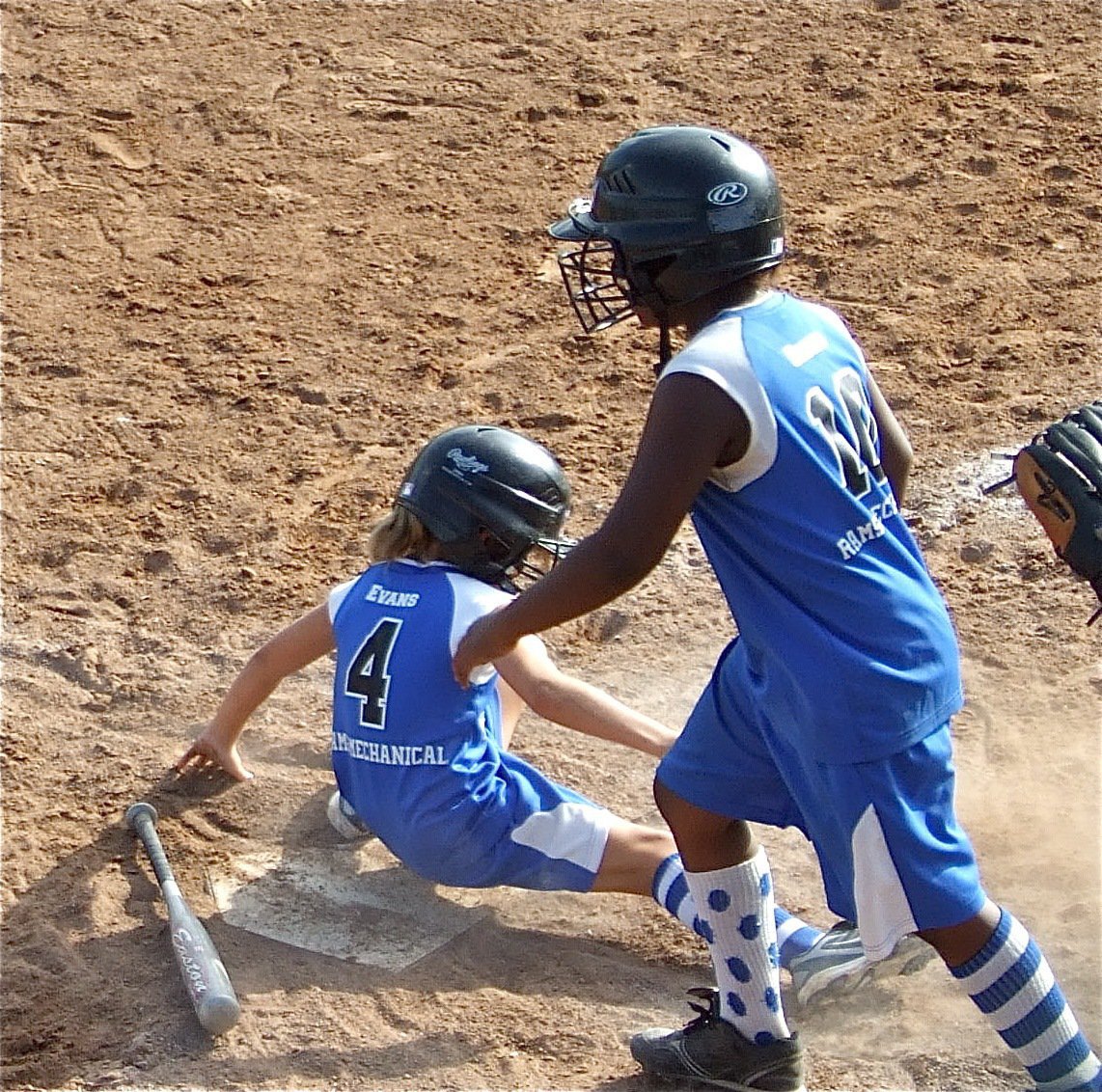 Image: Nice effort — A sliding Abbey Evans and Janaria Brooks try to put points on the board for Milford but the Ferris Scorpions manage the must win 13-4.