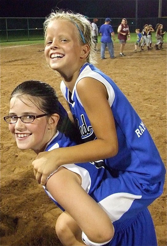 Image: We won! — In celebration, Sarah Sanders gives teammate Alex Jones a piggyback ride around the infield.