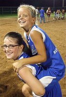 Image: We won! — In celebration, Sarah Sanders gives teammate Alex Jones a piggyback ride around the infield.