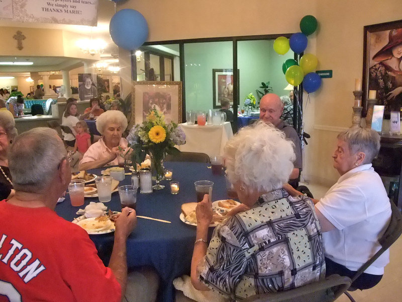 Image: Residents and Family  — Residents and friends eating together.
