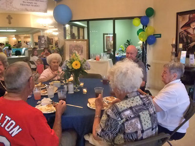 Image: Residents and Family  — Residents and friends eating together.