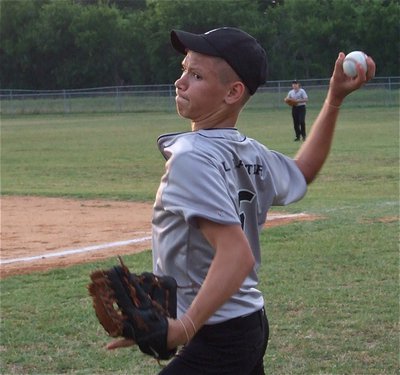 Image: Evans gets ready — Gladdog ace Eric Evans gets warmed up before pitching against Whitney as Tyler Crawley gets ready in right field.