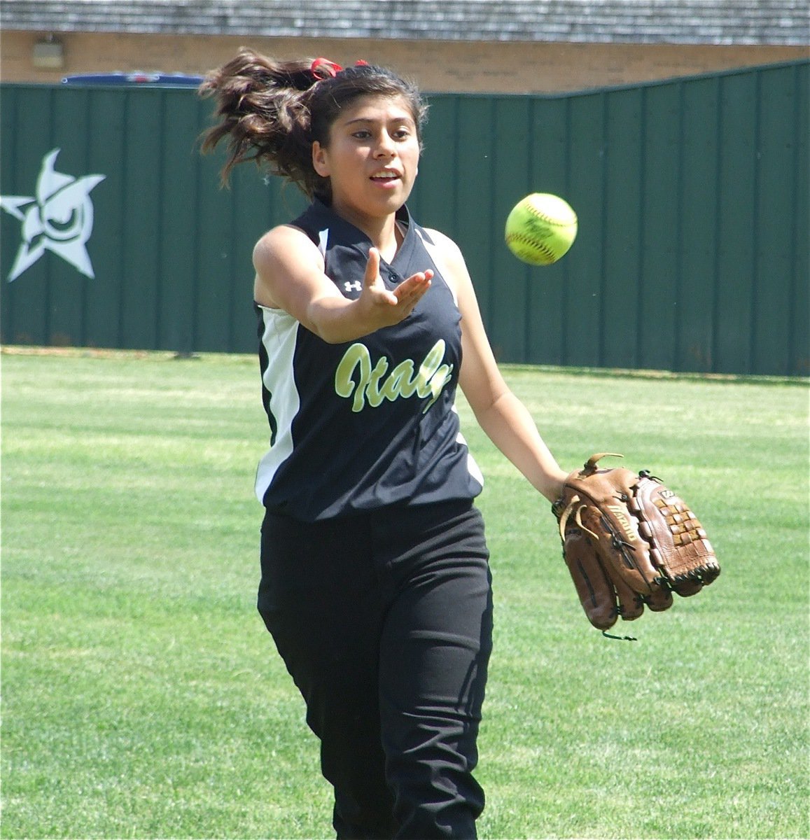 Image: Piece of cake — Lady Gladiator right fielder Alma Suaste lofts the ball to catcher Alyssa Richards after completing a warm-up drill.