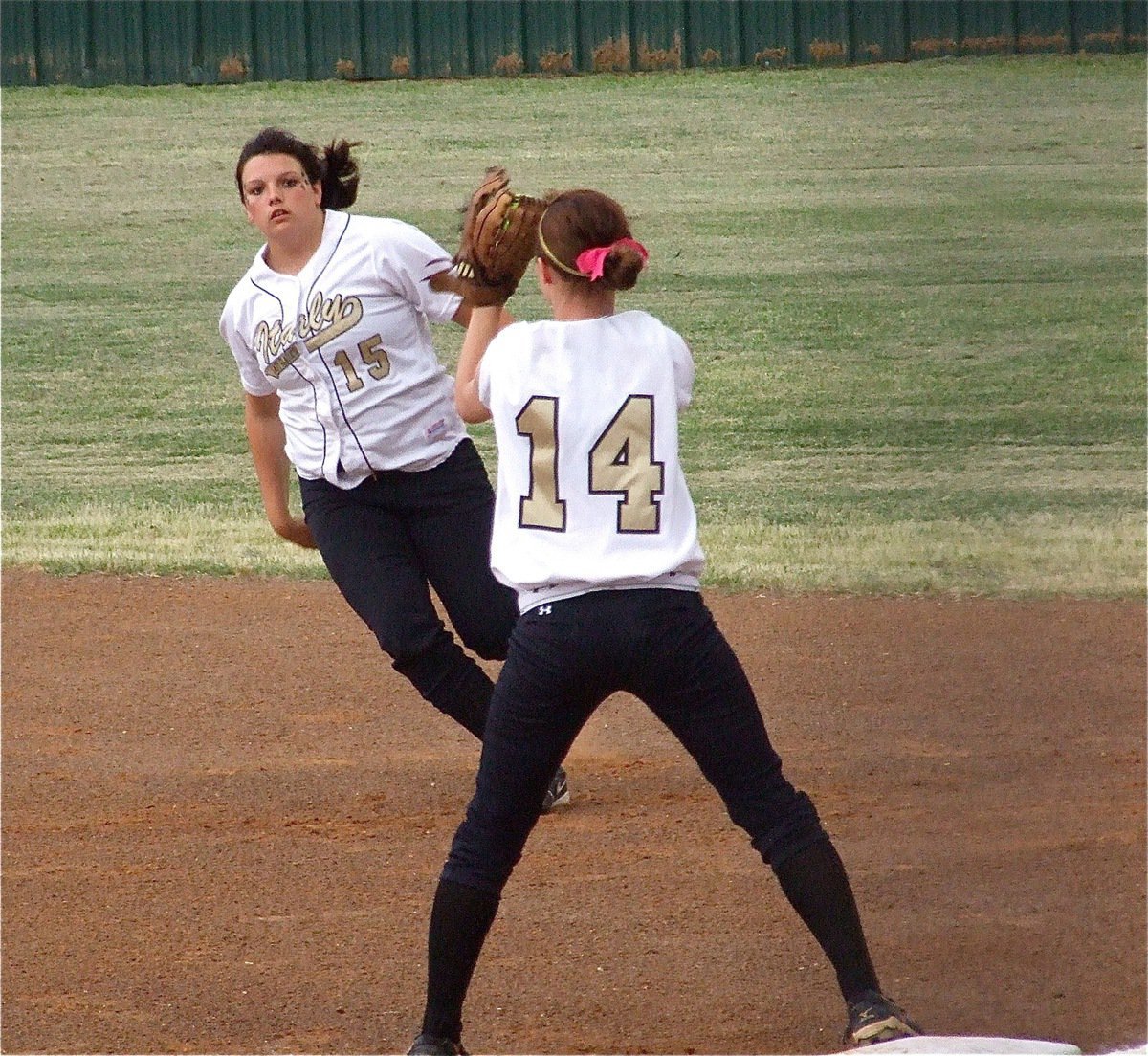 Image: Cori Jeffords(15) flips the ball to Drew Windham(14) for an out — Lady Gladiator second baseman Cori Jeffords(15) made defensive play after defensive play against Meridian in game one of the best 2-out of-3 regional quarterfinal-series on Thursday in Joshua. First baseman Drew Windham(14) caught every ball Jeffords tossed her as the two combined for 5 outs.