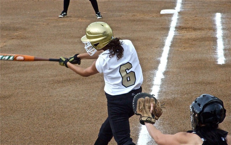 Image: Anna takes a swing — Anna Viers(6) tries to get the softball rolling for the Lady Gladiators against Meridian.