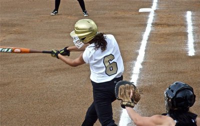 Image: Anna takes a swing — Anna Viers(6) tries to get the softball rolling for the Lady Gladiators against Meridian.