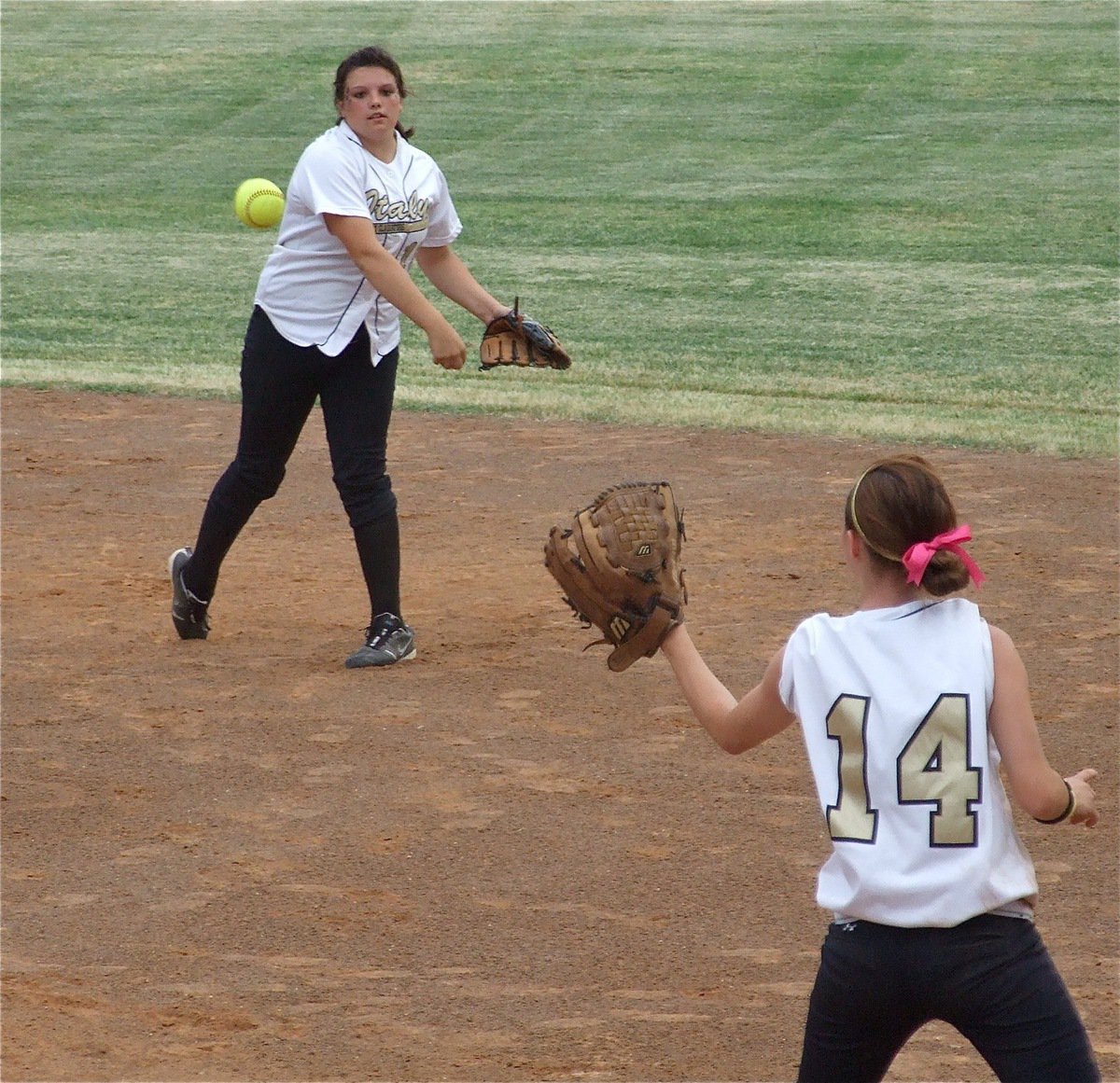 Image: Another out — Cori Jeffords(15) makes the stop and then throws to first baseman Drew Windham(14) for an out.