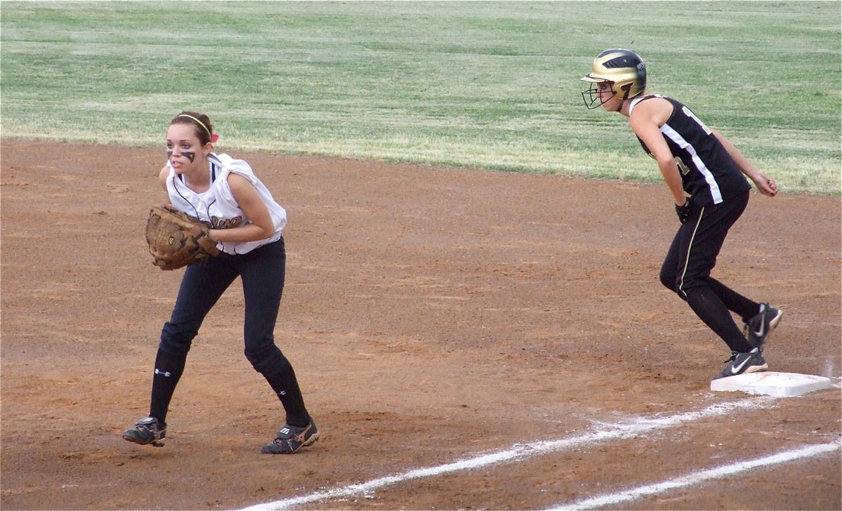 Image: Anticipating the bunt — Italy’s first baseman Drew Windham(14) creeps up expecting Meridian to attempt a bunt in an effort to advance the Lady ’Jacket runner to second base.