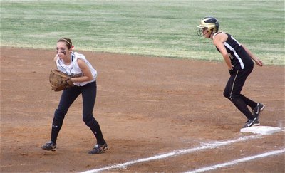 Image: Anticipating the bunt — Italy’s first baseman Drew Windham(14) creeps up expecting Meridian to attempt a bunt in an effort to advance the Lady ’Jacket runner to second base.