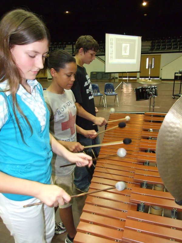 Image: It takes three — 7th graders Whitney Wolaver, Alex Minton-Fielder and Coby Jeffords work as a team during the Spring Concert.