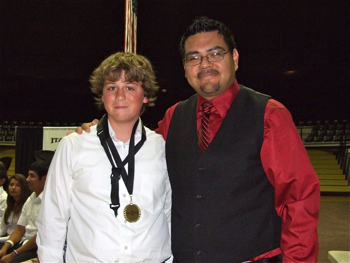 Image: Pitts honored — Joe Mack Pitts receives a medal from Jesus Perez.