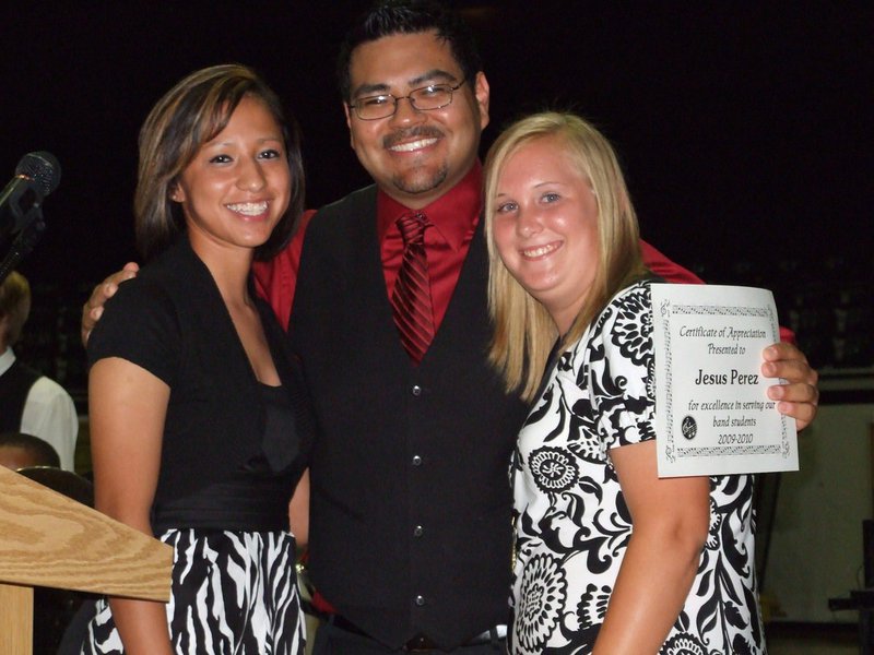Image: Jessica, Perez & Drenda — The tables have turned – Italy High School Band Director Jesus Perez graciously accepts his Certificate of Appreciation from the Gladiator Regiment Band with Jessica Hernandez and Drenda Burk presenting.