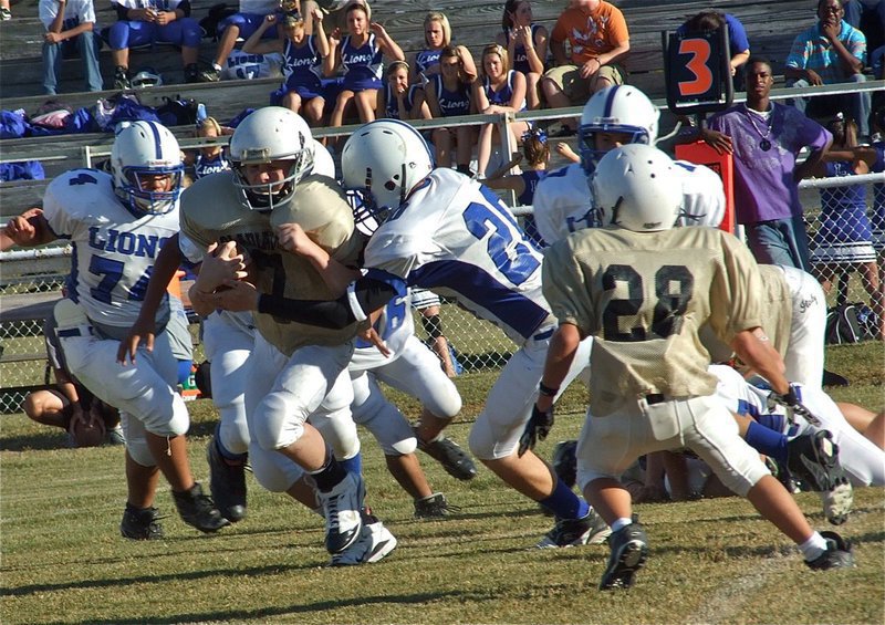 Image: Busting thru — John Escamilla(7) powers his way into the Blooming Grove secondary.