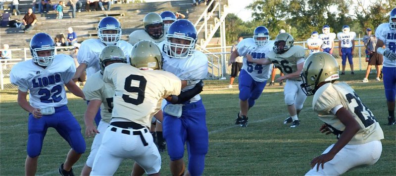 Image: In the grasp — Trevon Robertson(9) gets help from Eric Carson(28) in bringing down a Blooming Grove runner.