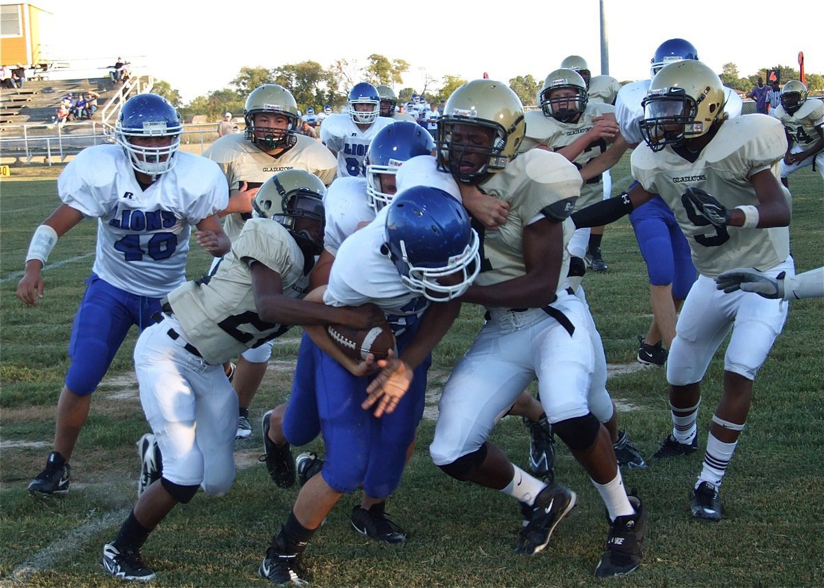 Image: Working together — Italy’s Eric Carson(28) and teammate Paul Harris(7) team up for the takedown.