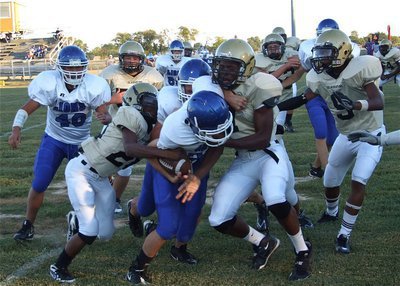 Image: Working together — Italy’s Eric Carson(28) and teammate Paul Harris(7) team up for the takedown.