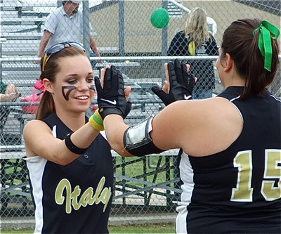 Image: Here we go — Seniors Drew Windham and Cori Jeffords slap hands during the pre-game introductions.