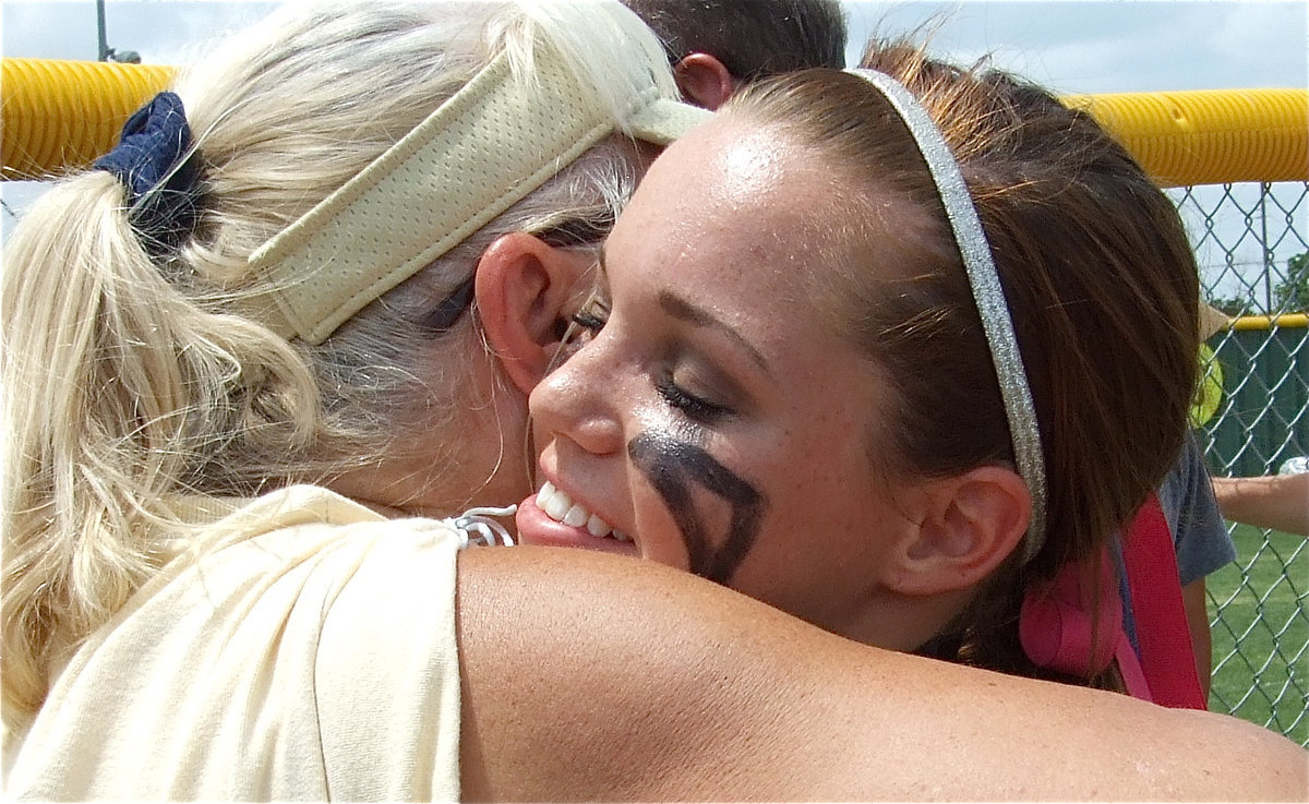 Image: Love you, Drew! — Rita Garza gives senior Drew Windham a long hug after the game.