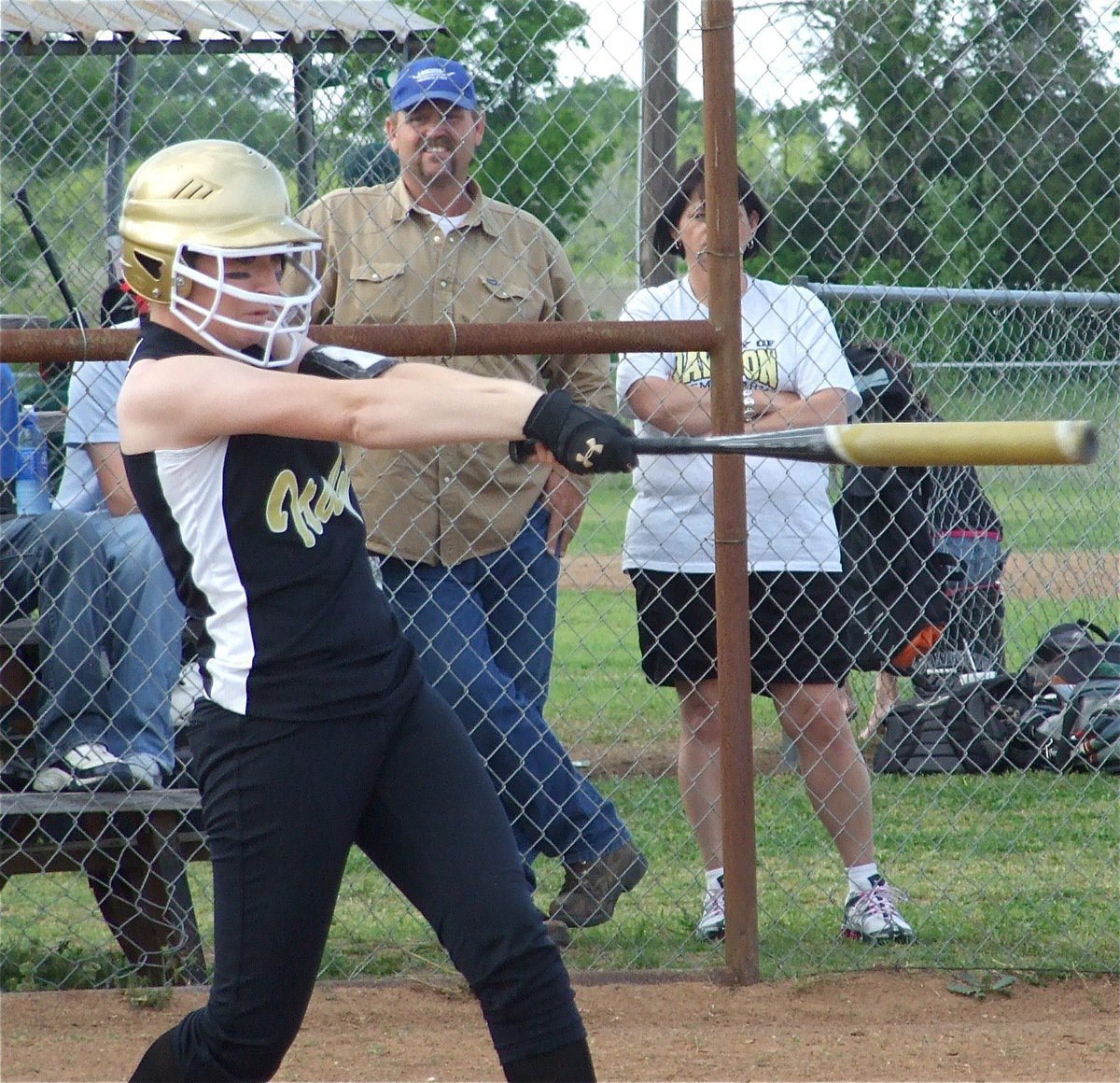 Image: Fetch this! — Bailey Bumpus knocks a 3-run triple over the heads of the Dawson Lady Bulldog’s defense.