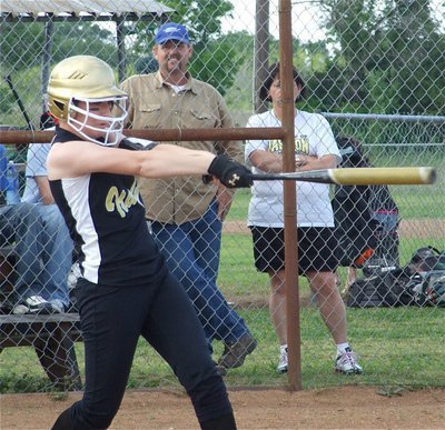 Image: Fetch this! — Bailey Bumpus knocks a 3-run triple over the heads of the Dawson Lady Bulldog’s defense.