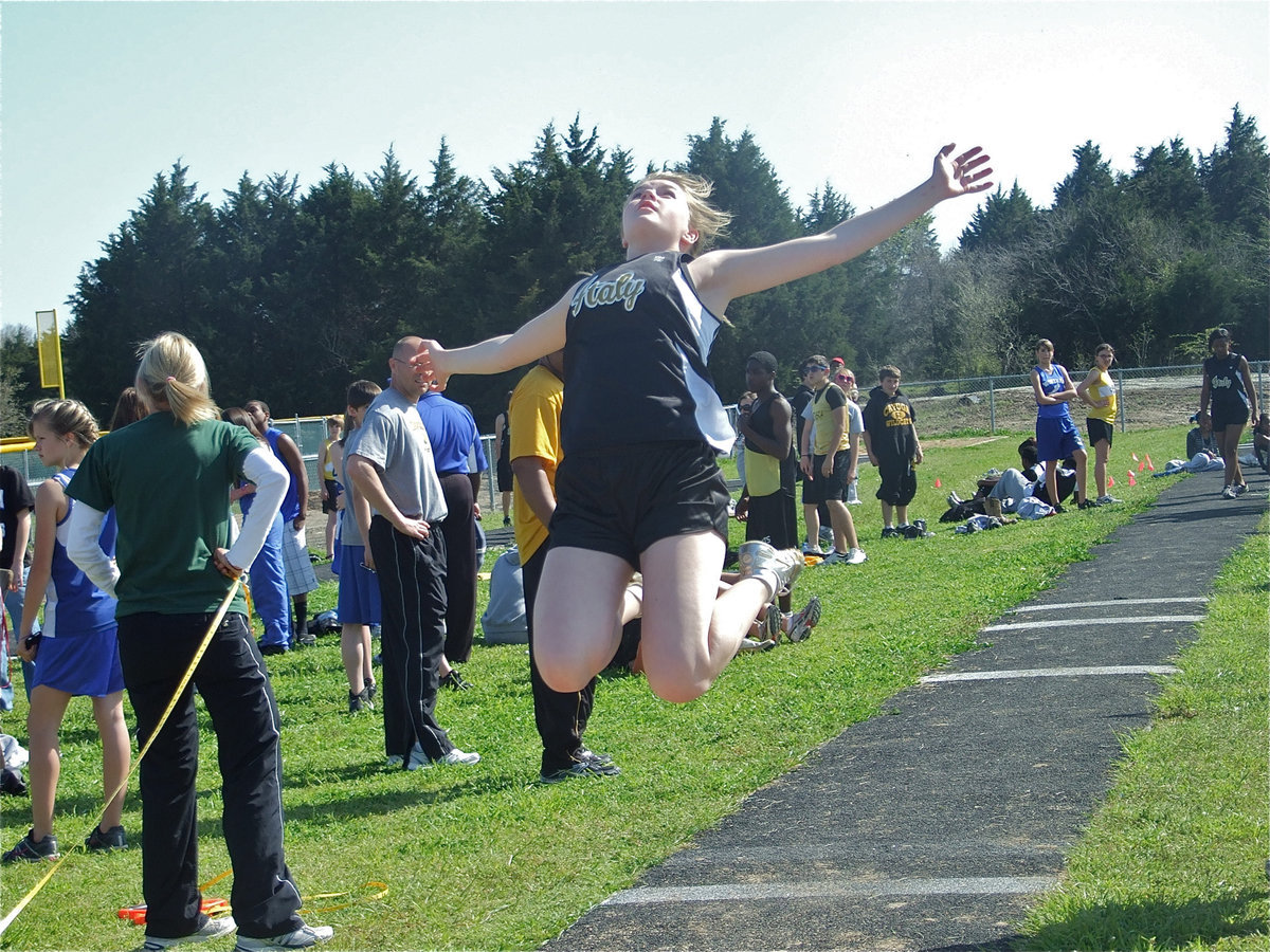 Image: Taylor Turner defies gravity during the District track meet — 8th grader Taylor Turner was a force to reckon with at the district track meet in Hubbard. Turner placed in both the triple jump and the long jump during the field events.