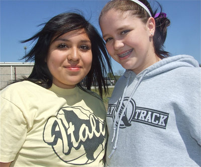 Image: Monserrat &amp; Paige — 8th graders Monserrat Figueroa and Paige Westbrook take a time out while practicing at the shot put.