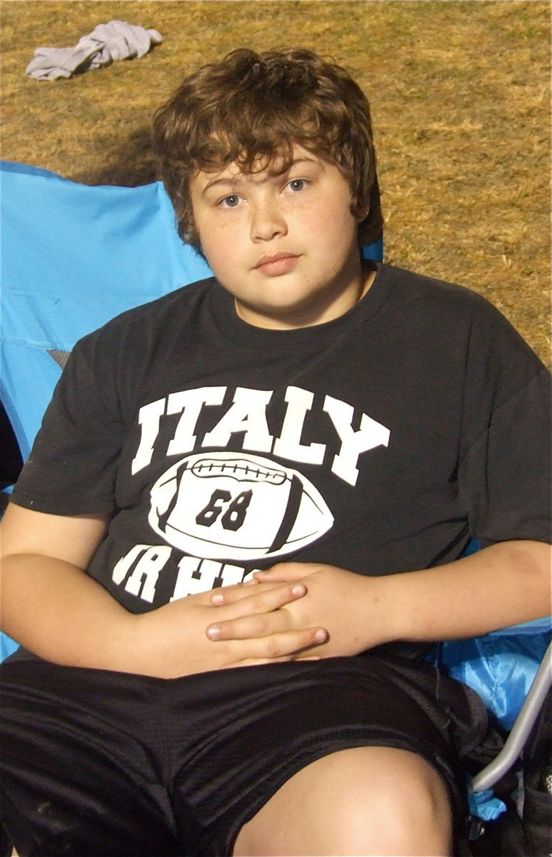 Image: That’s my boy! — Perhaps impressing Vacuna, the Roman Goddess of leisure, 8th grader Zain Byers seems right at home at the district track meet in Hubbard.