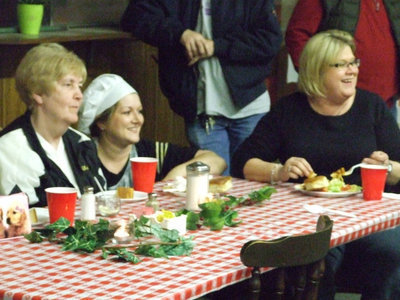 Image: Having fun — Miss Birdie Bell, Clover Stiles and Kathy Haight watch as the auction items bring in the money for the Italy Regiment Band.