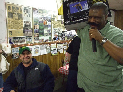 Image: The Winner! — Billy Burkhalter delivers the flat-screen TV to the winning ticket, Steve Chambers a.k.a. “John Deere”.
