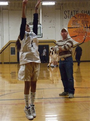 Image: Elisha shoots — Italy 14 coach, Jerry Glenn, studies Elisha McClendon’s(1) jump shot before the game.